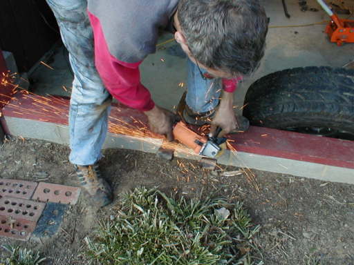 Using a 4 inch grinder to cut off the main leaf's eye. This will bolt right up to your existing main leaf.