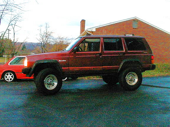 Lifted Jeep Cherokee XJ with 31" tires and 3.4L engine.
